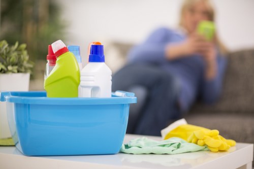 Professional office cleaners dusting desks and sanitising shared surfaces